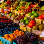 Fresh fruit stand with boysenberries, raspberries, cherries and grapes