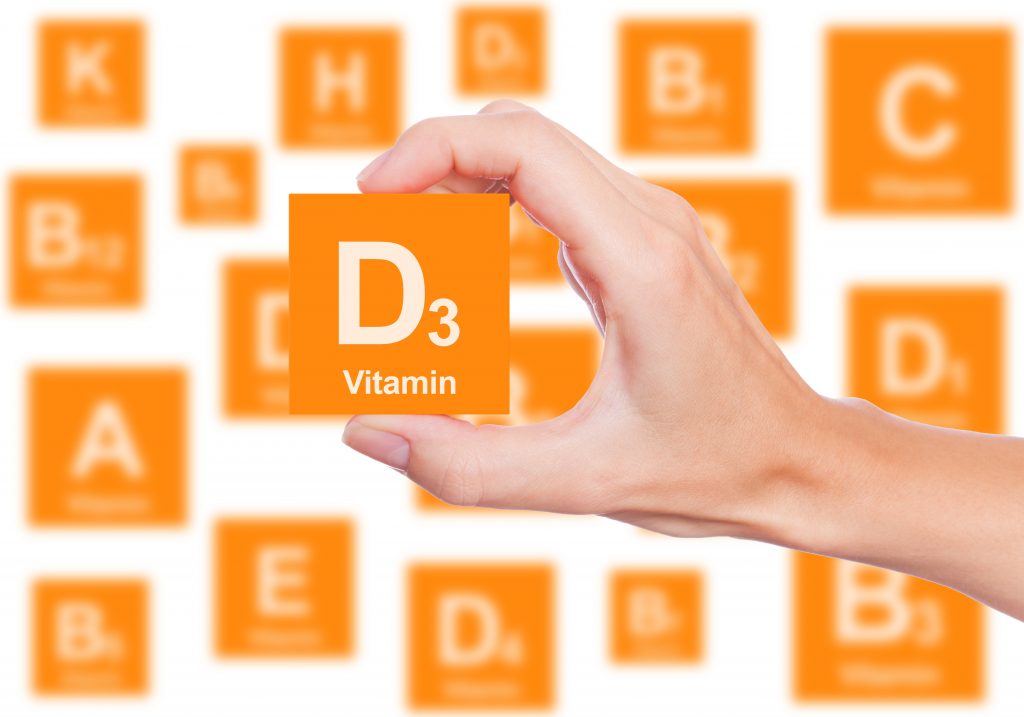 Hand holds a box of vitamin D3